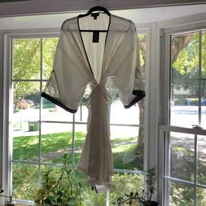 White satin robe with black trim and lace detail